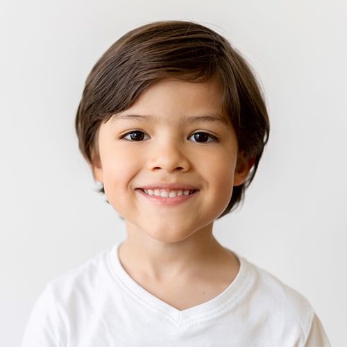 A boy smiling after his fluoride treatment