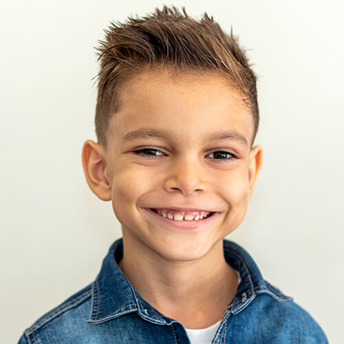 A boy smiling after his frenectomy treatment
