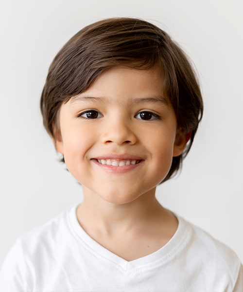 A boy smiling after his fluoride treatment